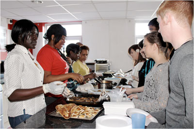 Young people and staff at Slough Foyer cook and enjoy a meal together as part of the project's final celebration.